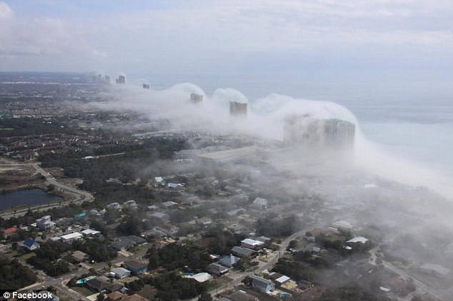 Low-lying haze: Helicopter pilot JR Hott captured the series of images as fog swept over the land within minutes